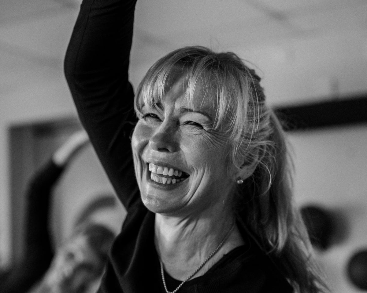 A barre trainer laughing mid-class